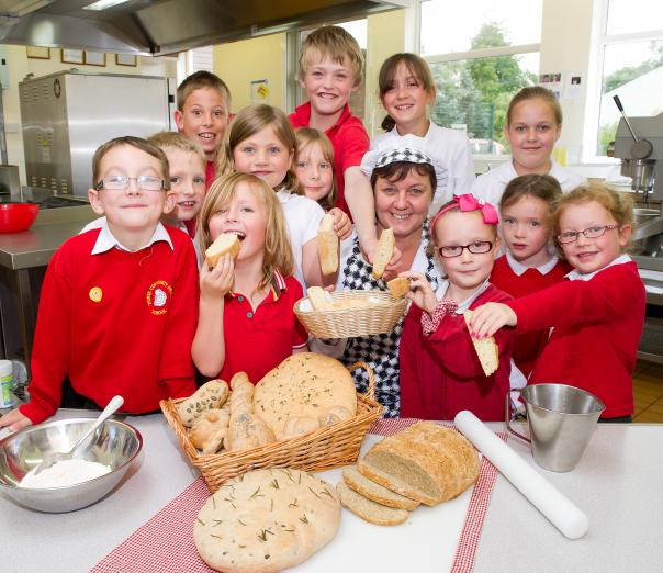 Lesley Christon gets Thirsk Community Primary School pupils to try her freshly baked bread