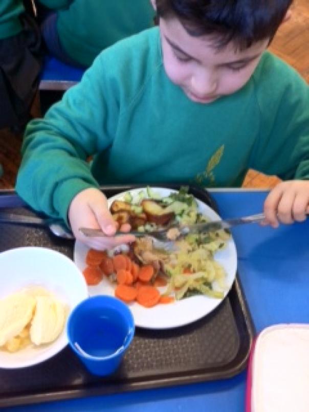 Photo of pupil eating school meals